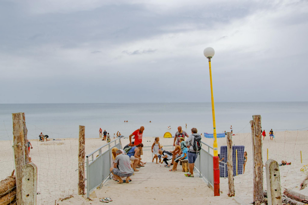 Relaxed beach atmosphere with people enjoying summer at Świętouść, Poland.